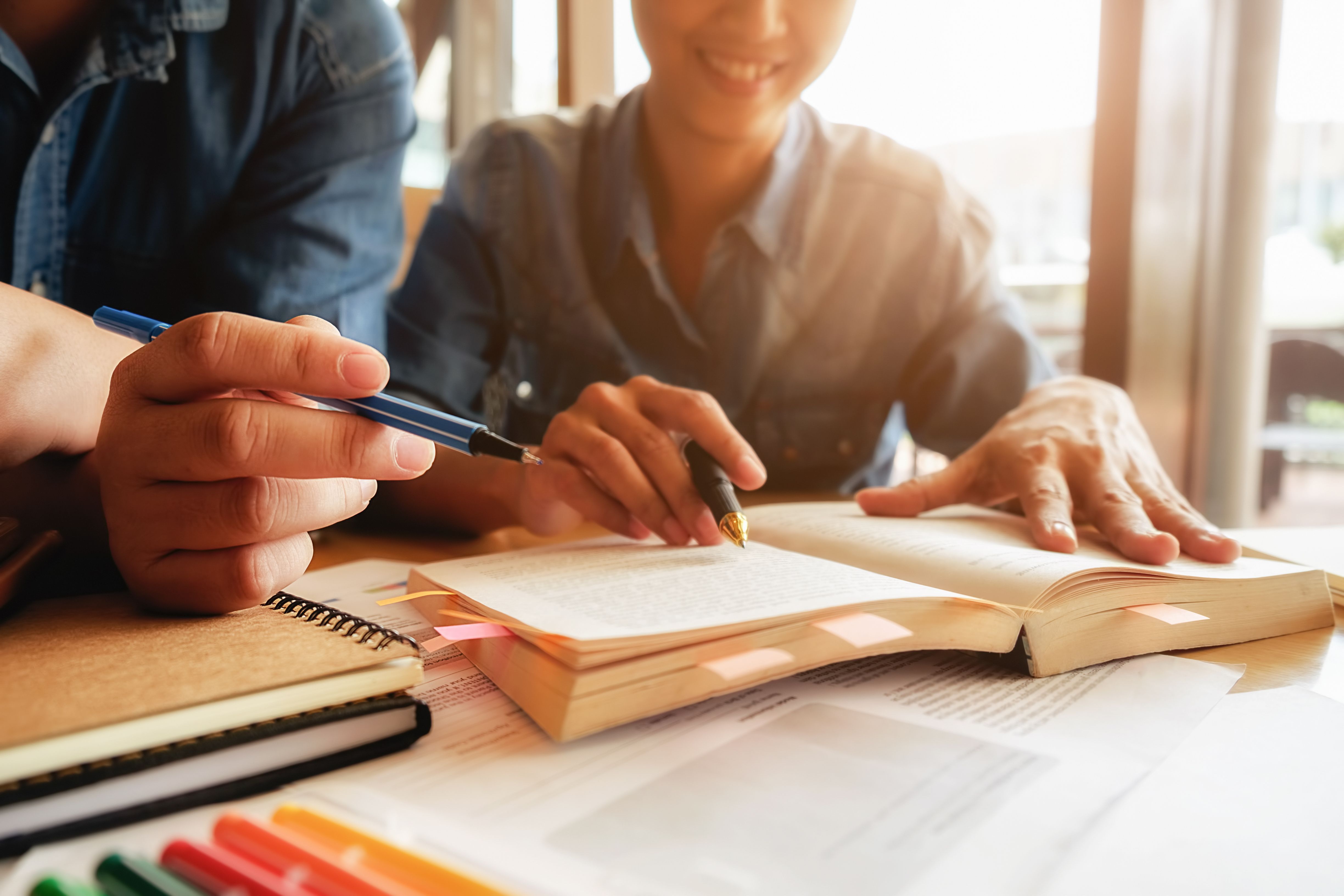 education-concept-student-studying-brainstorming-campus-concept-close-up-students-discussing-their-subject-books-textbooks-selective-focus.jpg